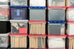 plastic storage bins with documents inside