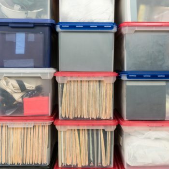 plastic storage bins with documents inside